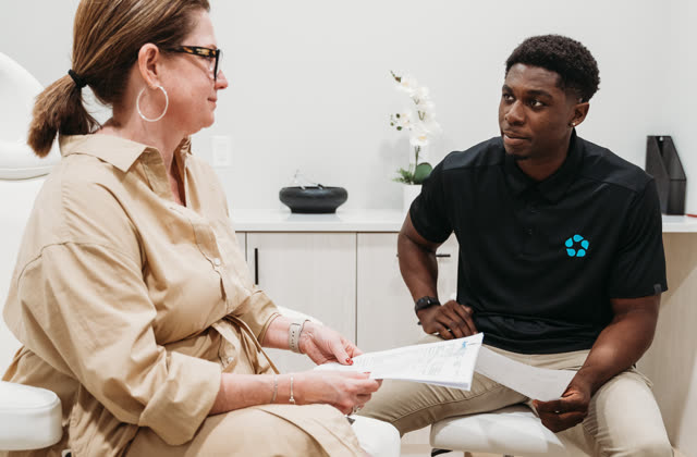 A provider reviews hormone lab results with a patient