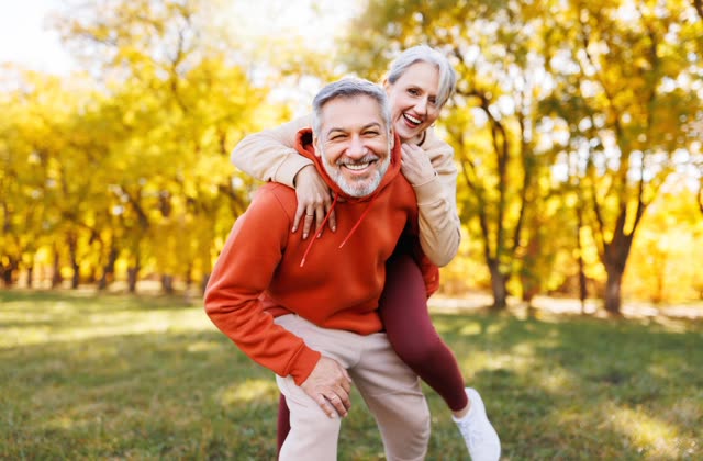 A happy couple laughing together outdoors