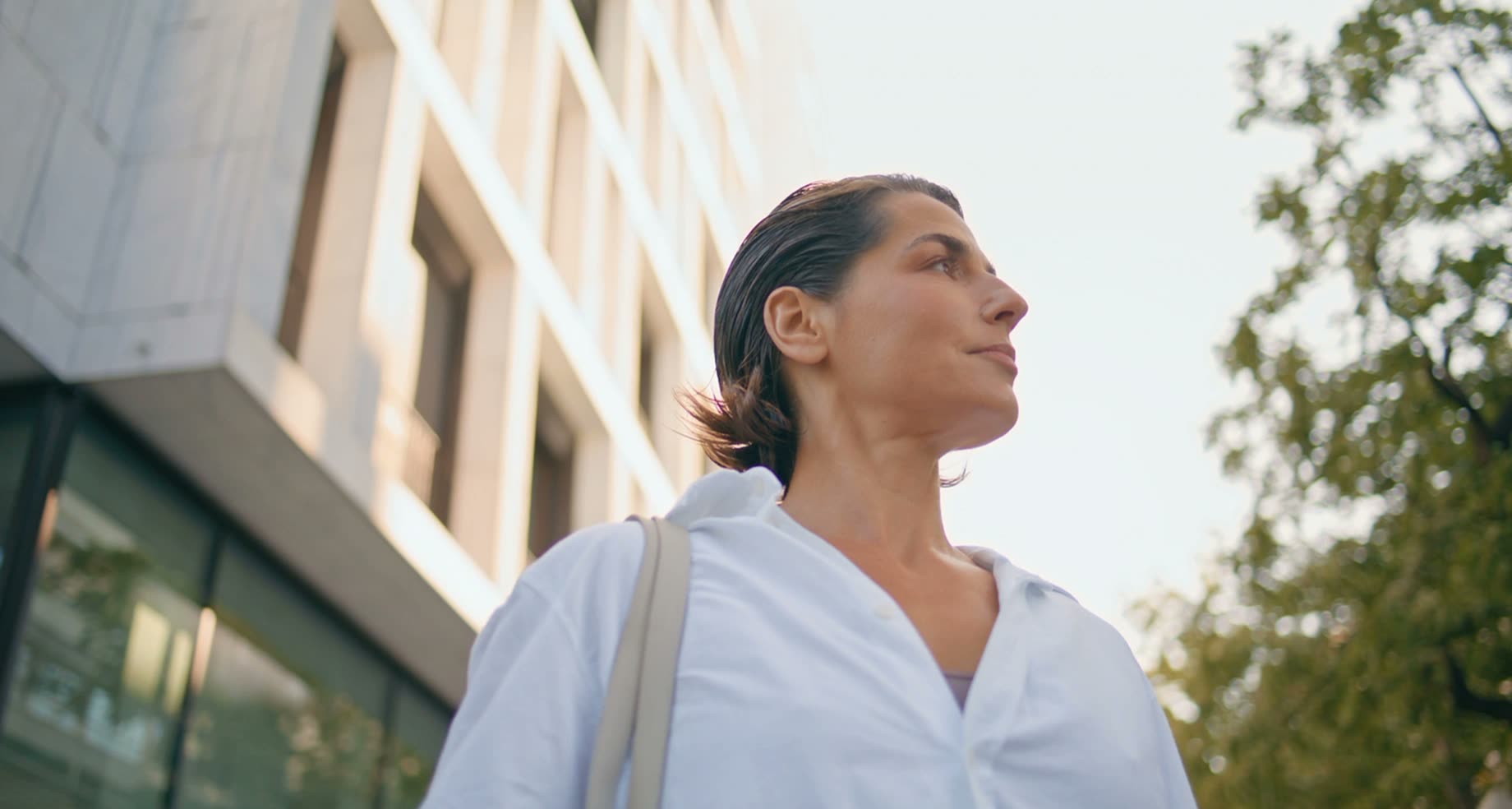 A confident woman outdoors on a bright morning